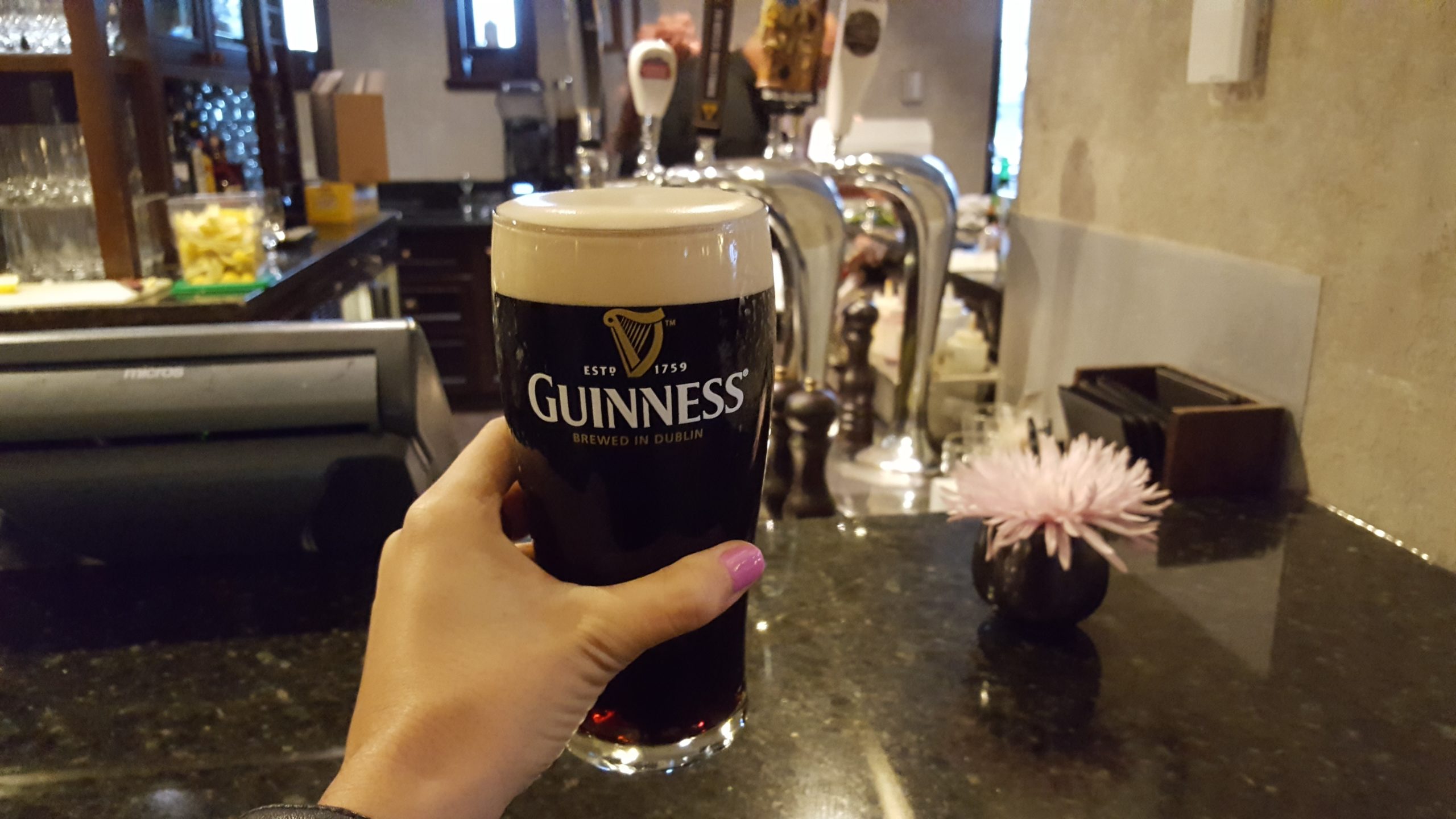 Girl's hand holding Guinness How to Drink Guinness